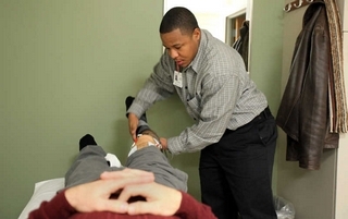Physical therapist tech Dallas Mitchell's de Quervain's tendonitis started at his job, in which he uses a repetitive, circular motion to work ultrasound machinery in as many as a dozen procedures each day.   (ANDRE J. JACKSON/Detroit Free Press)